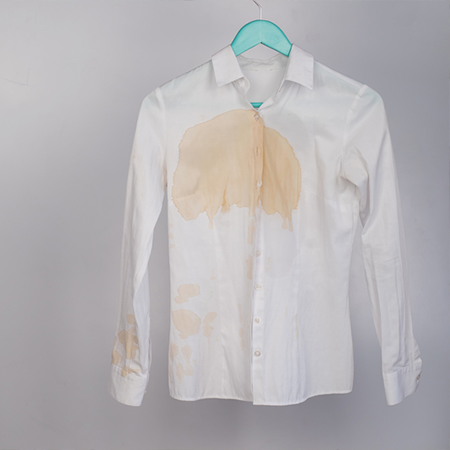A white shirt with a large coffee stain