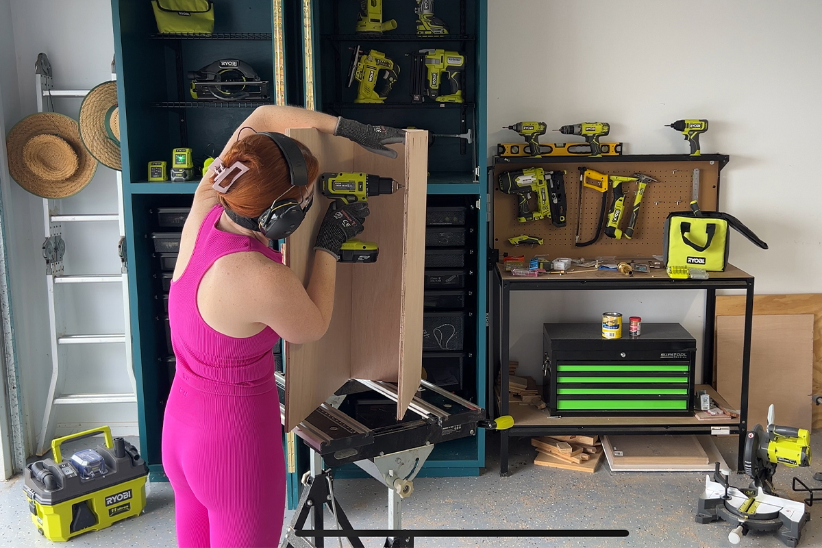 Emma uses a RYOBI Drill Driver to assemble cabinet storage