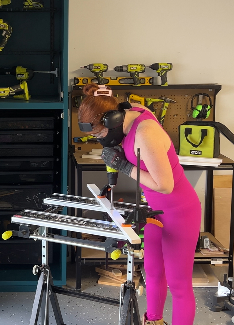 Emma drills into a strip of timber with a RYOBI drill driver