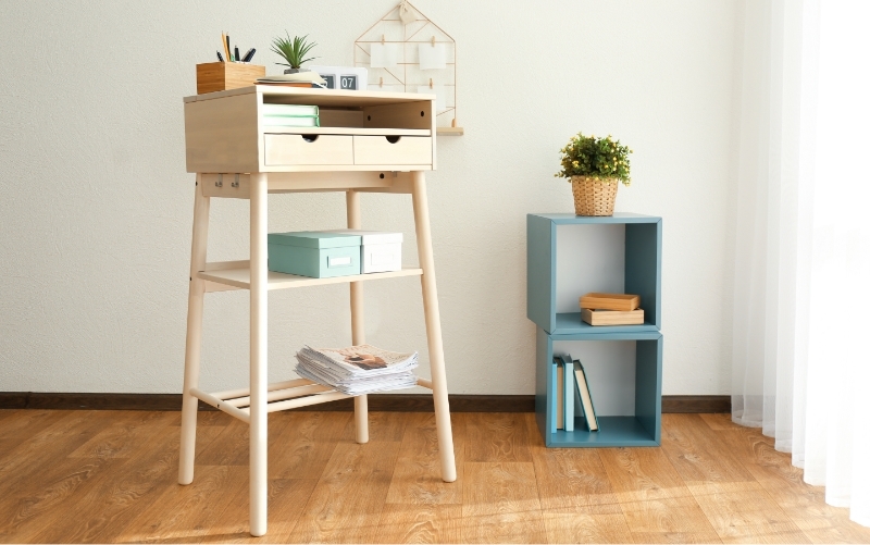 A DIY standing home office with a desk and storage cubes