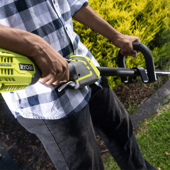 A man using a RYOBI Brushless Line Trimmer