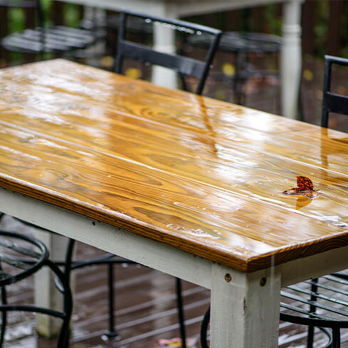 A wet outdoor table and chairs