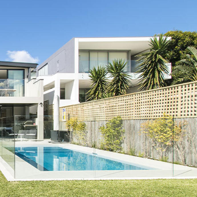 Glass pool fence in backyard